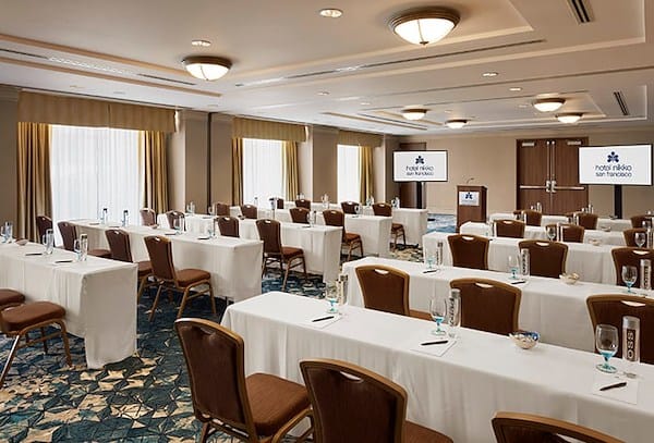 Event Space in Hotel Fusion, bright meeting room setup for workshops and presentations.