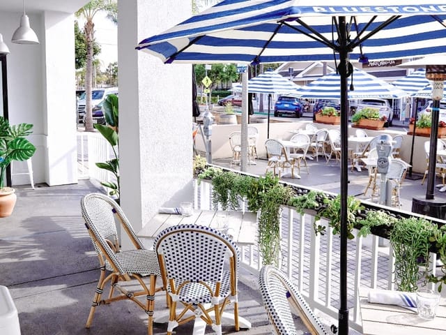 Outdoor seating area at Santa Monica Bluestone Lane, ideal for casual meetings and networking.