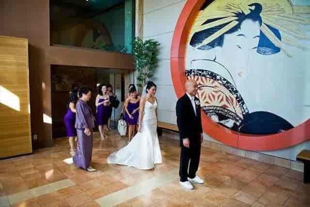 Wedding at Hotel Kabuki with bride in elegant gown and artistic mural backdrop.