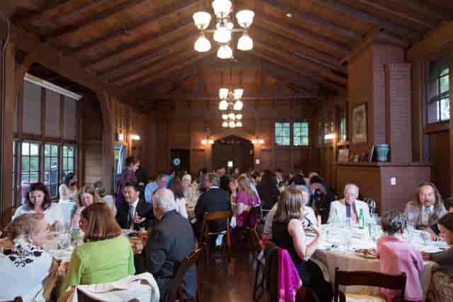 Elegant dining event at Julia Morgan Hall with warm wood tones and inviting atmosphere.