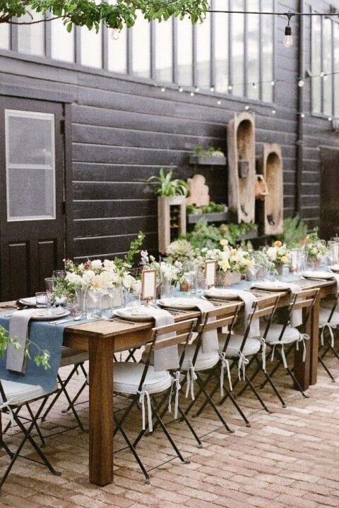 Elegant long table with floral centerpieces at French Oak Ranch event.