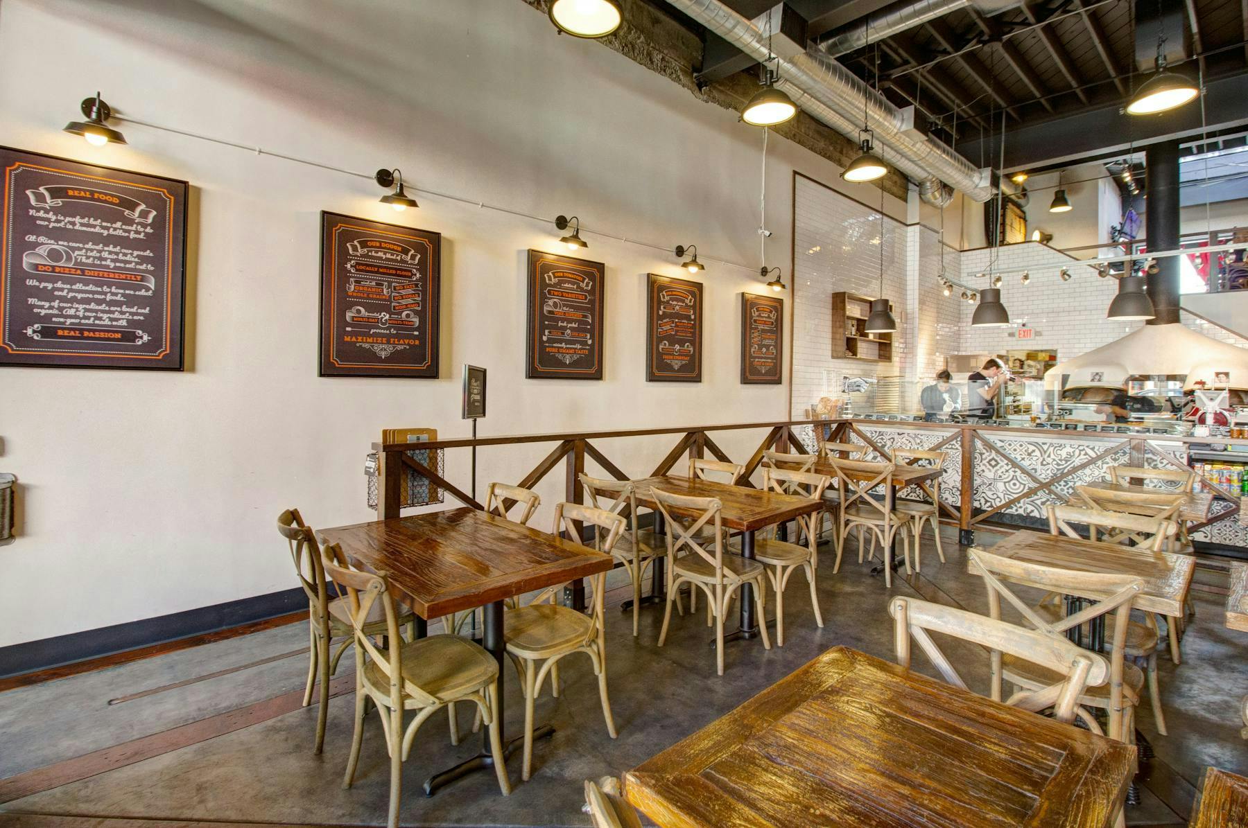 Modern Rise Pizzeria interior, warm wood tones, ideal for networking events and casual meetings.