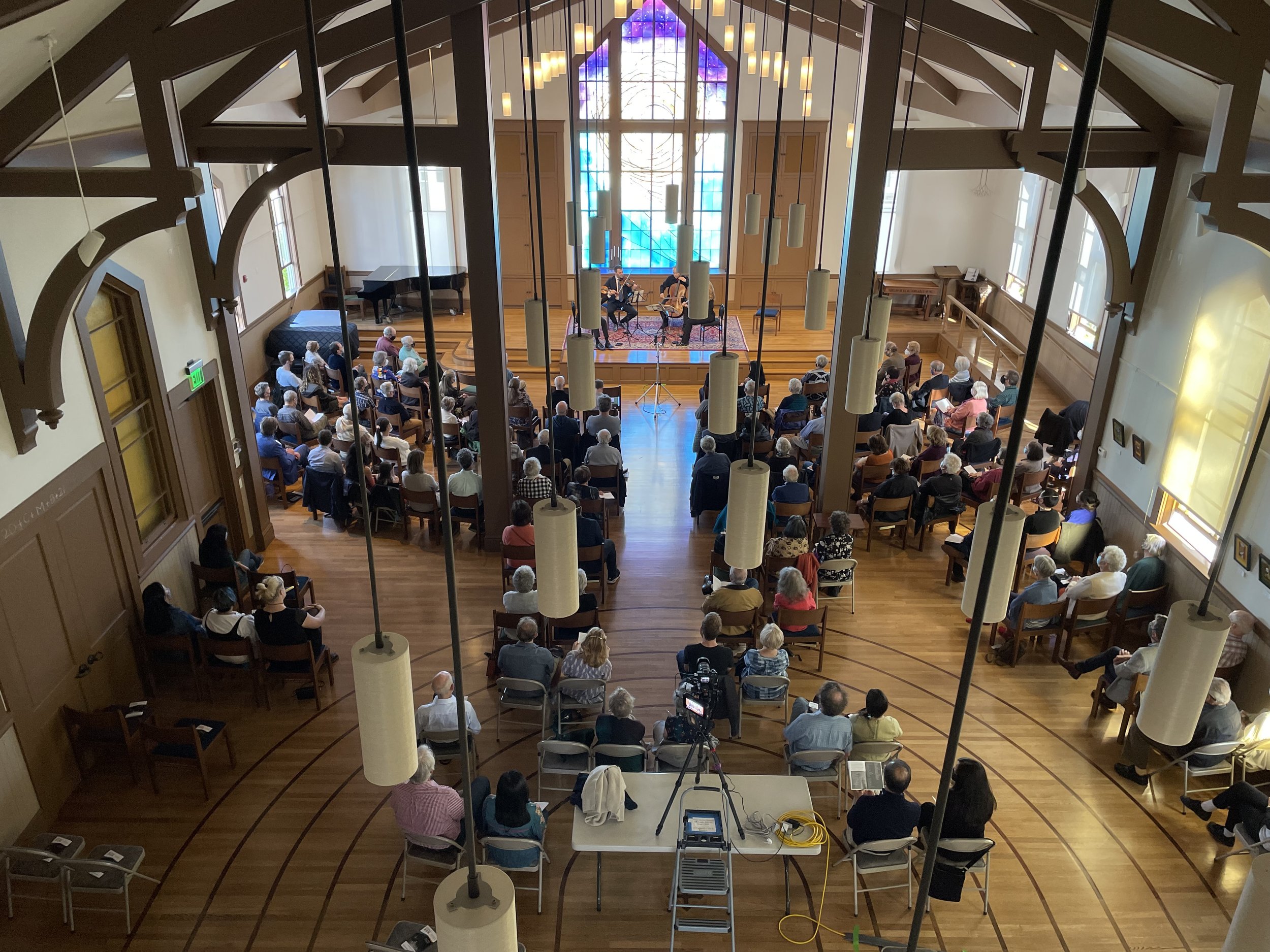 Noe Valley Ministry event with attendees in semi-circle, bright and engaging atmosphere.