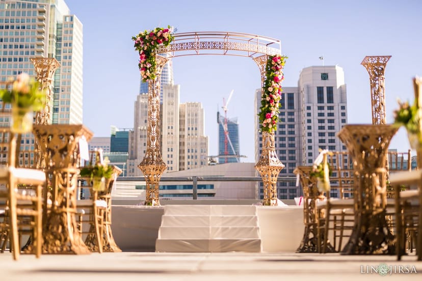 City View Event Space outdoor wedding with floral arch and skyline backdrop.