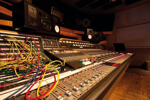 Control room with audio mixing console for high-quality sound in events.