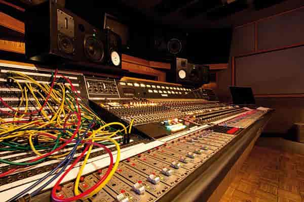 Control room with audio mixing console for high-quality sound in events.