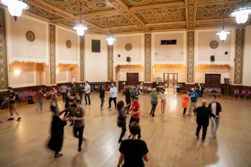 Ballroom dance event at Lake Merritt with elegant wooden floor and ornate ceiling.