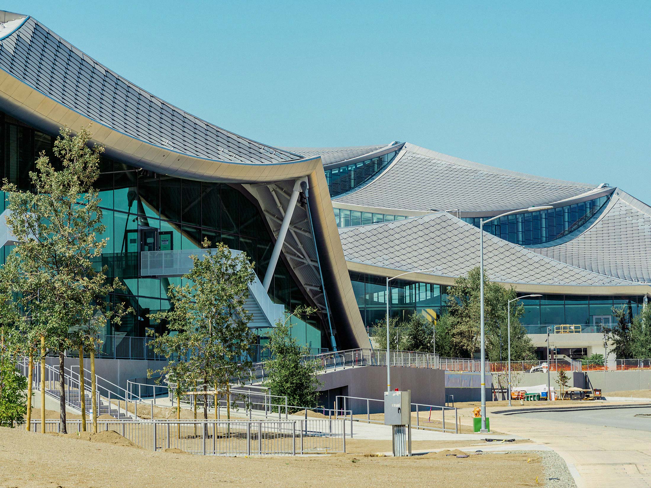 Modern venue with glass facades for meetings and events in a green setting.