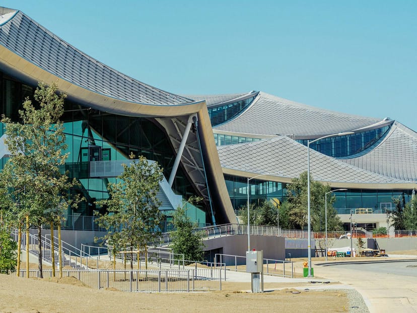 Modern venue with glass facades for meetings and events in a green setting.