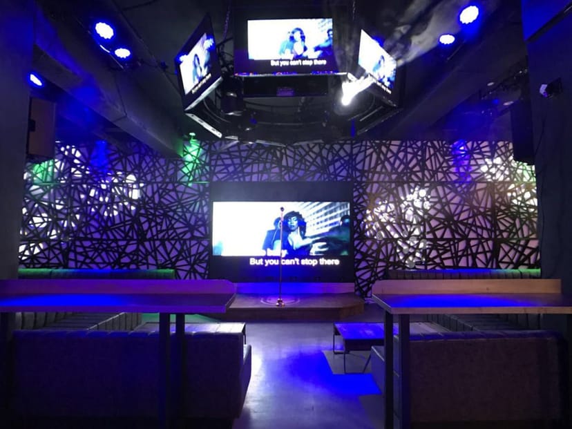 Modern Pandora Karaoke event space with large screen, ideal for networking and parties.