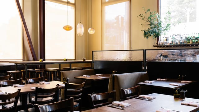 Stylish Nopa restaurant interior with warm lighting, ideal for networking events and dining.