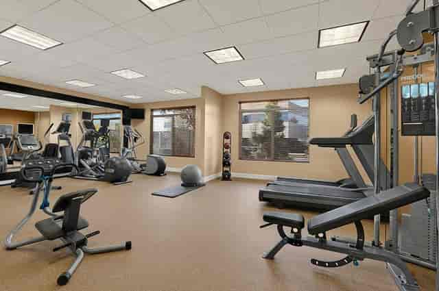 Fitness room at Hilton Garden Inn SFO with modern machines for wellness events.