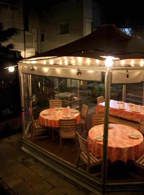 Outdoor dining area with warm lighting, perfect for intimate gatherings and events.