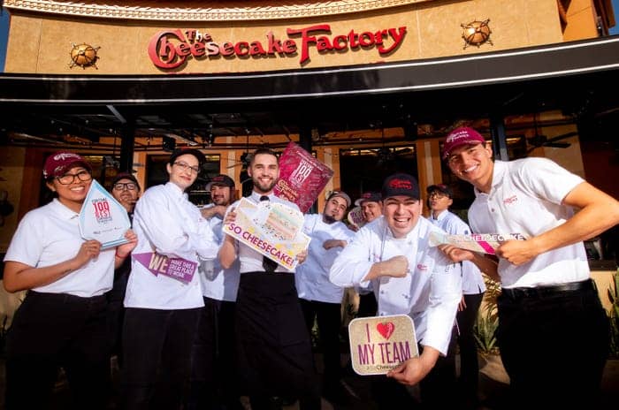 Cheesecake Factory staff outside, showcasing team spirit for memorable events and gatherings.