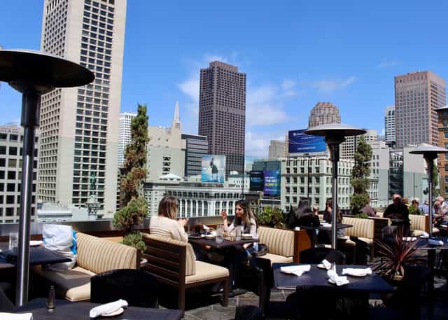 Rooftop bakery venue with stylish seating and city skyline for events and receptions.