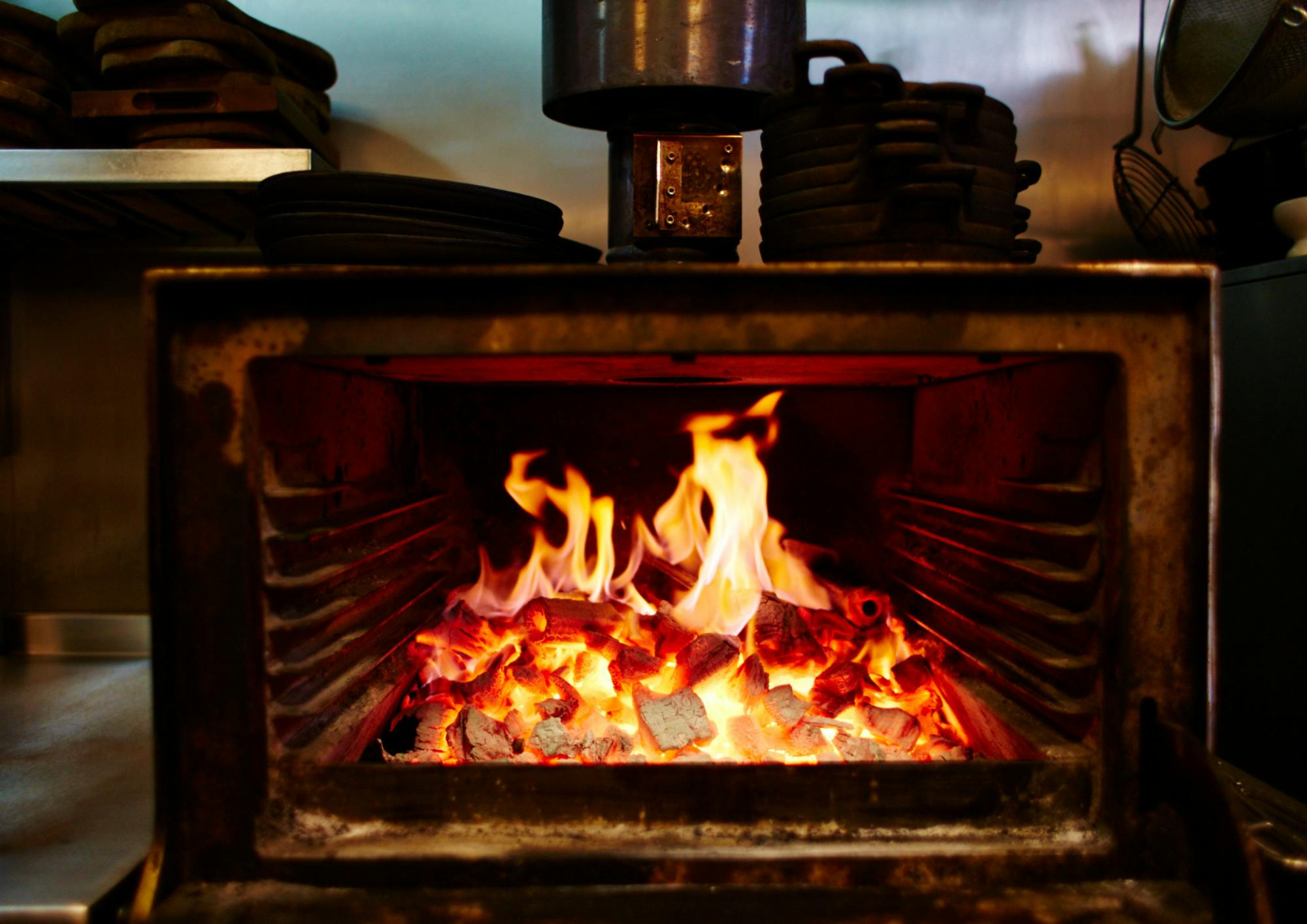 Private dining room with vibrant fire, perfect for culinary events and interactive dining.