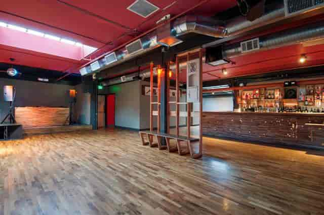 Versatile event space in Public Works SF with polished wooden floors for meetings and receptions.