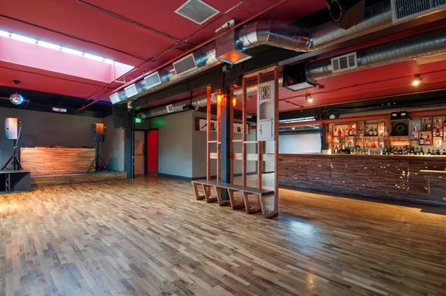 Versatile event space in Public Works SF with polished wooden floors for meetings and receptions.