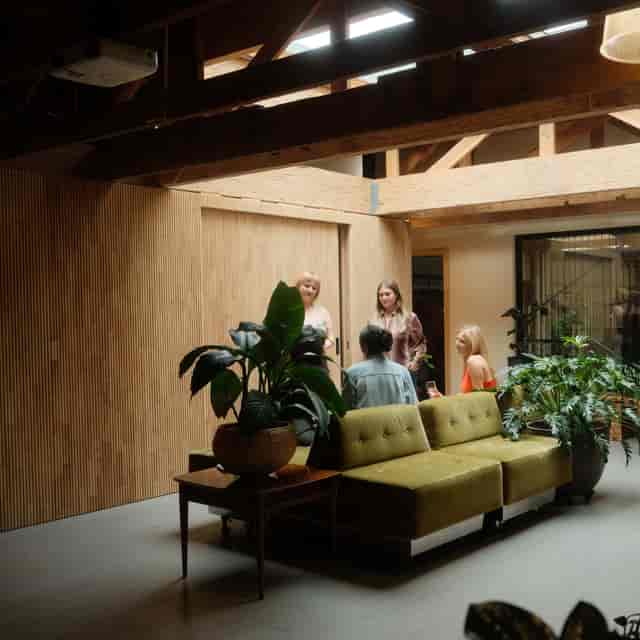 Modern meeting space with natural light and greenery, ideal for networking events and workshops.