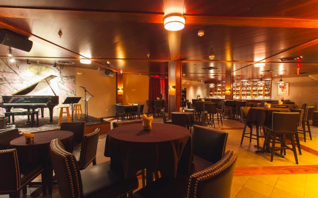 Mr. Tipples' Recording Studio with round tables, warm lighting for events and live music.