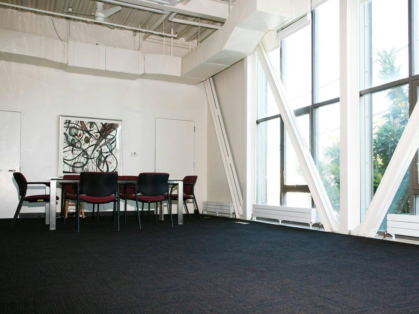 Spacious Chris Hellman Studio with natural light, ideal for workshops and meetings.