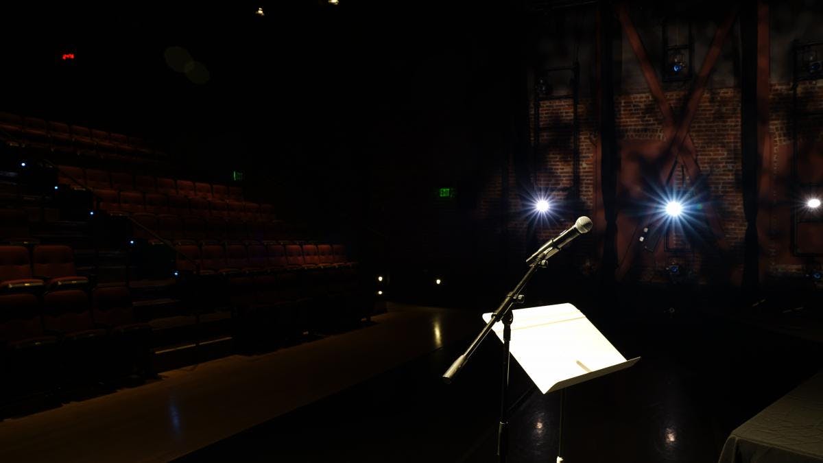 ODC Theater lobby stage set for performance with microphone and music stand.