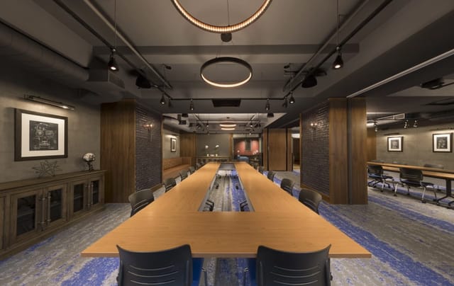 Modern conference room in The Helm with a long wooden table for professional events.