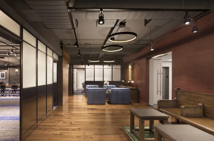Modern meeting space in The Helm with warm wood flooring for events and gatherings.