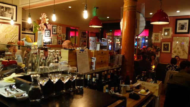 Intimate wine bar in InoVino with warm lighting, ideal for networking events and gatherings.