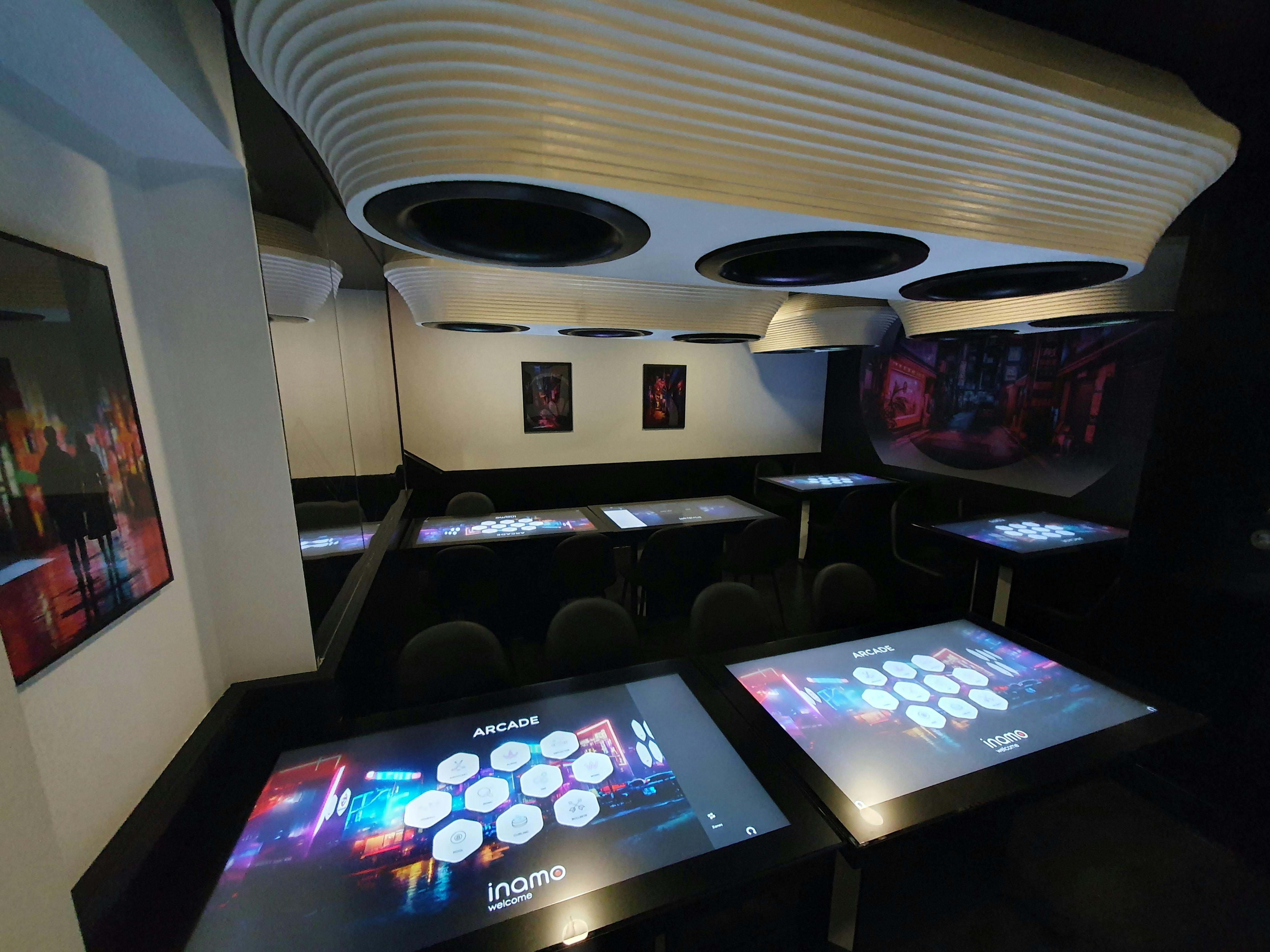 Modern event space at Inamo Wardour Street with tech-integrated tables for meetings.