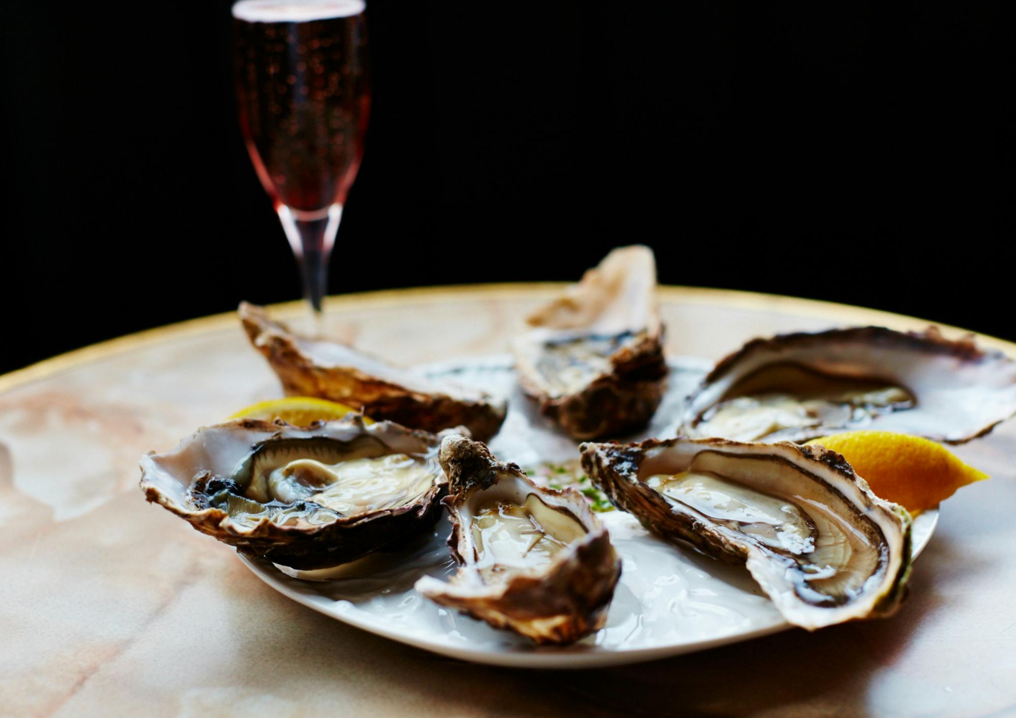 Elegant oysters and sparkling drink at Patron Restaurant for upscale events.