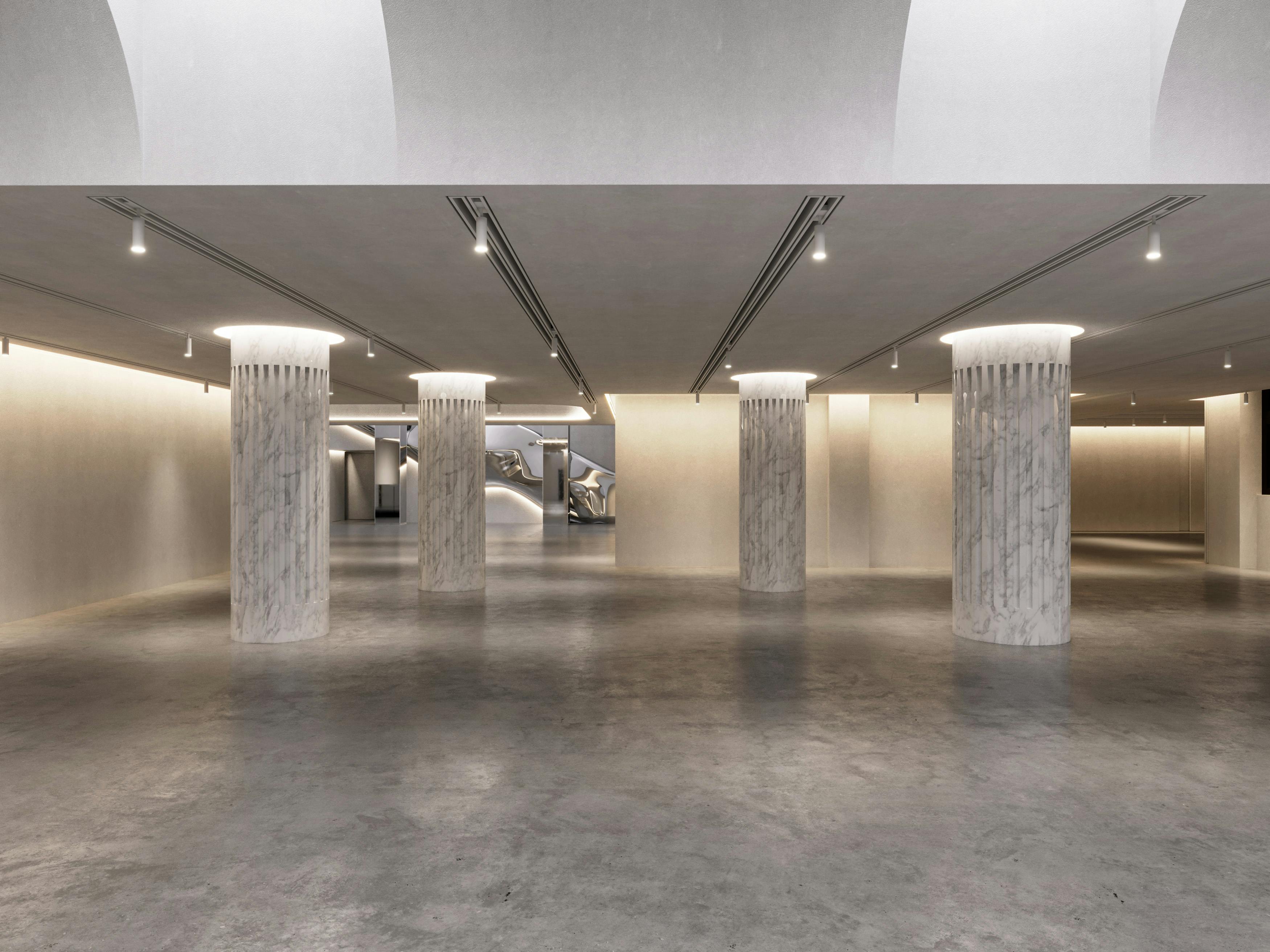 Modern event venue with polished concrete floor, ideal for networking and exhibitions.