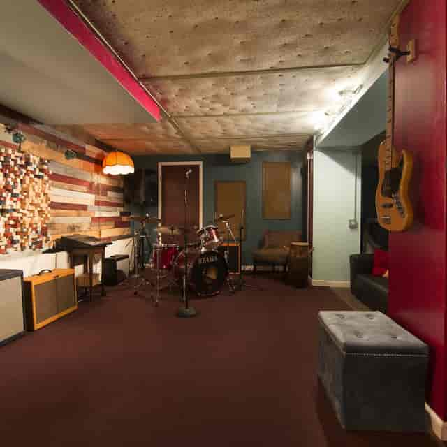 Cozy recording studio with warm lighting, ideal for live performances and networking events.