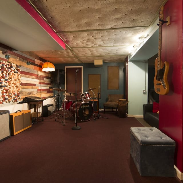 Cozy recording studio with warm lighting, ideal for live performances and networking events.