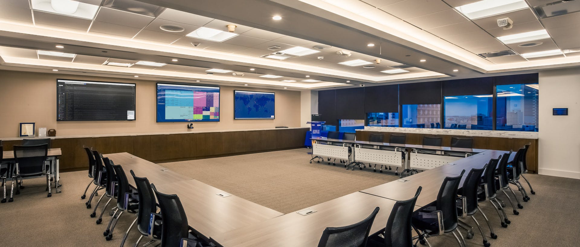 Modern conference room with U-shaped table for collaborative meetings and presentations.