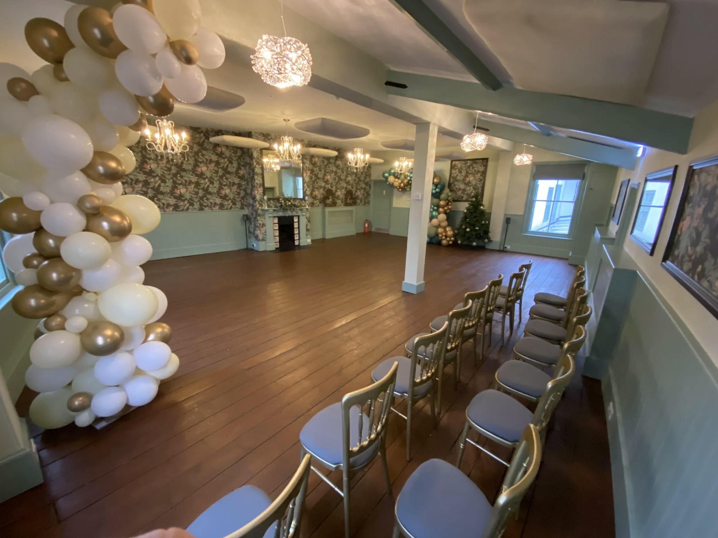 Large conference room with elegant balloon decor for weddings and corporate events.