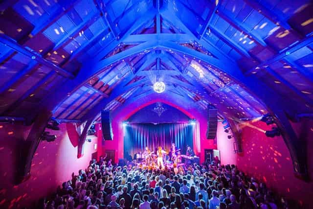 Vibrant event space with high ceilings, ideal for concerts and corporate events.
