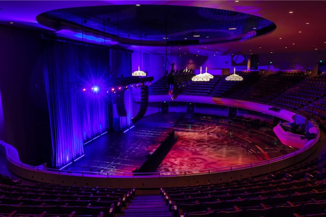 Elegant SF Masonic Auditorium event space with purple-lit stage and tiered seating.