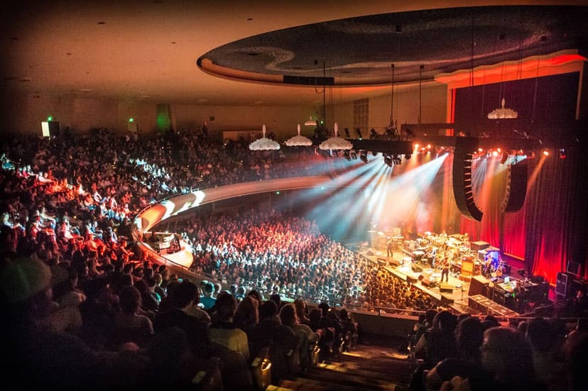 Vibrant concert in SF Masonic Auditorium with dynamic lighting and engaged audience.