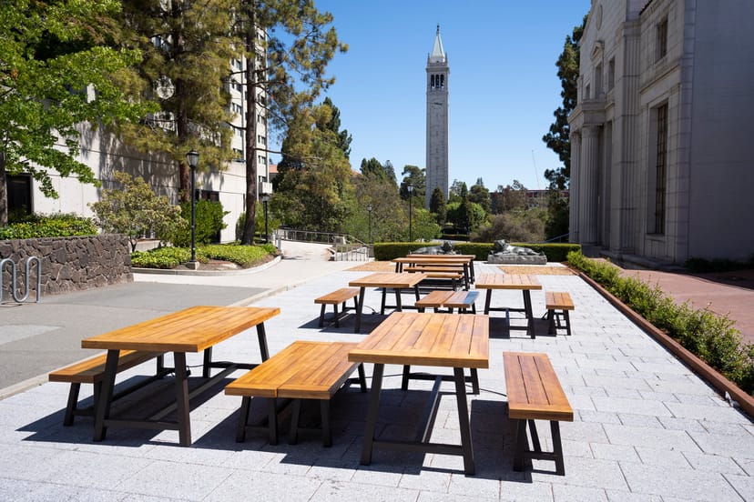 Banatao Room outdoor event space with wooden tables, ideal for networking and meetings.