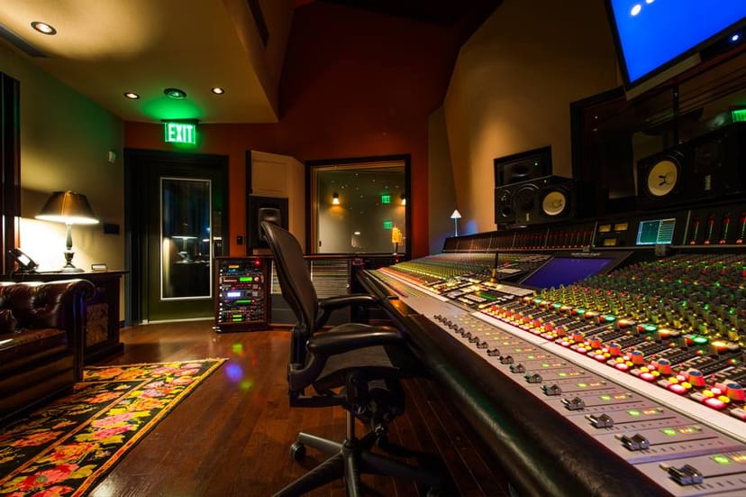 Professional recording studio with sleek soundboard for corporate events and workshops.