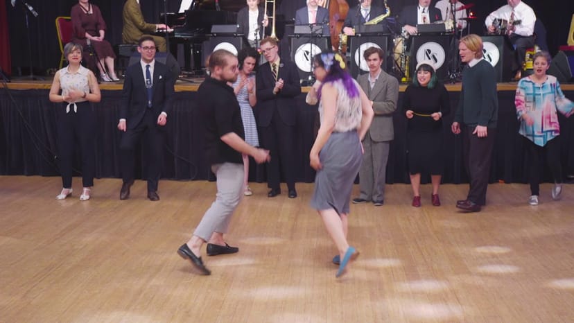 Lively dance floor at Shimmytown event with diverse attendees and live band.