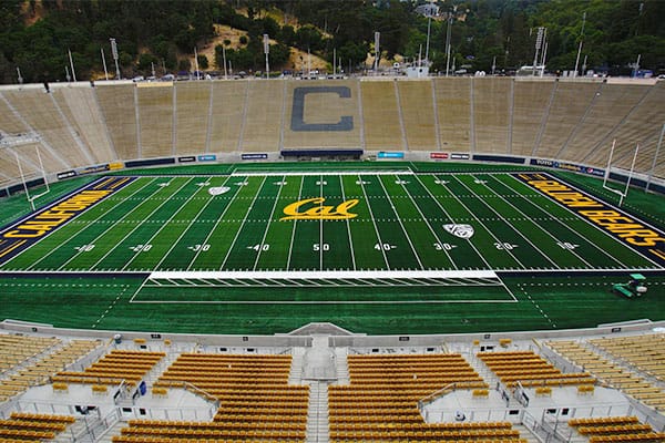 California Memorial Stadium with green football field, ideal for sports and corporate events.
