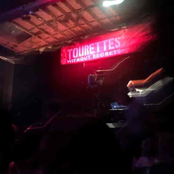 Operahouse Oakland event with vibrant lighting for "Tourettes Without Regrets" performance.