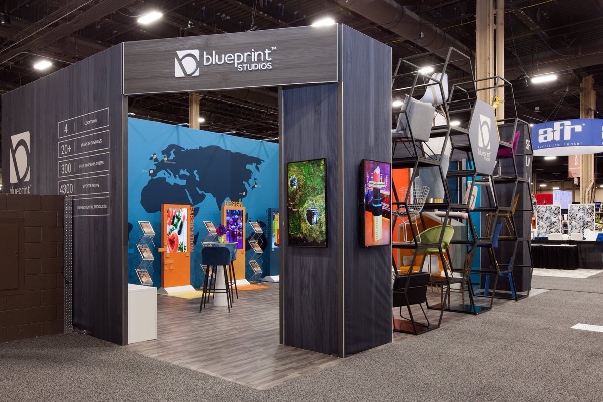 Modern exhibition booth at Blueprint Studios with vibrant graphics for event marketing.