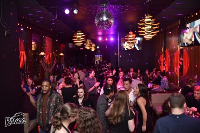 Vibrant Club Raven event space with disco ball, perfect for parties and networking.