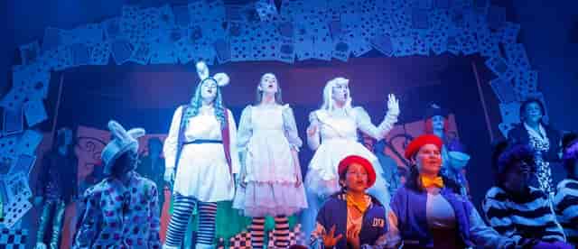 Vibrant theatrical performance at The Rabbit Hole Theater with colorful costumes for events.