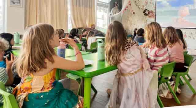 Vibrant children's event at The Rabbit Hole Theater with colorful tables and engaged kids.