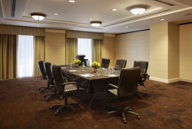 Conference room with large table and executive chairs for professional meetings.