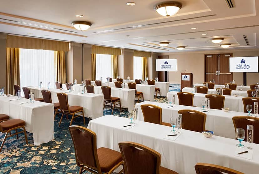 Corporate event space with rows of tables and natural light at Feinstein's Nikko.
